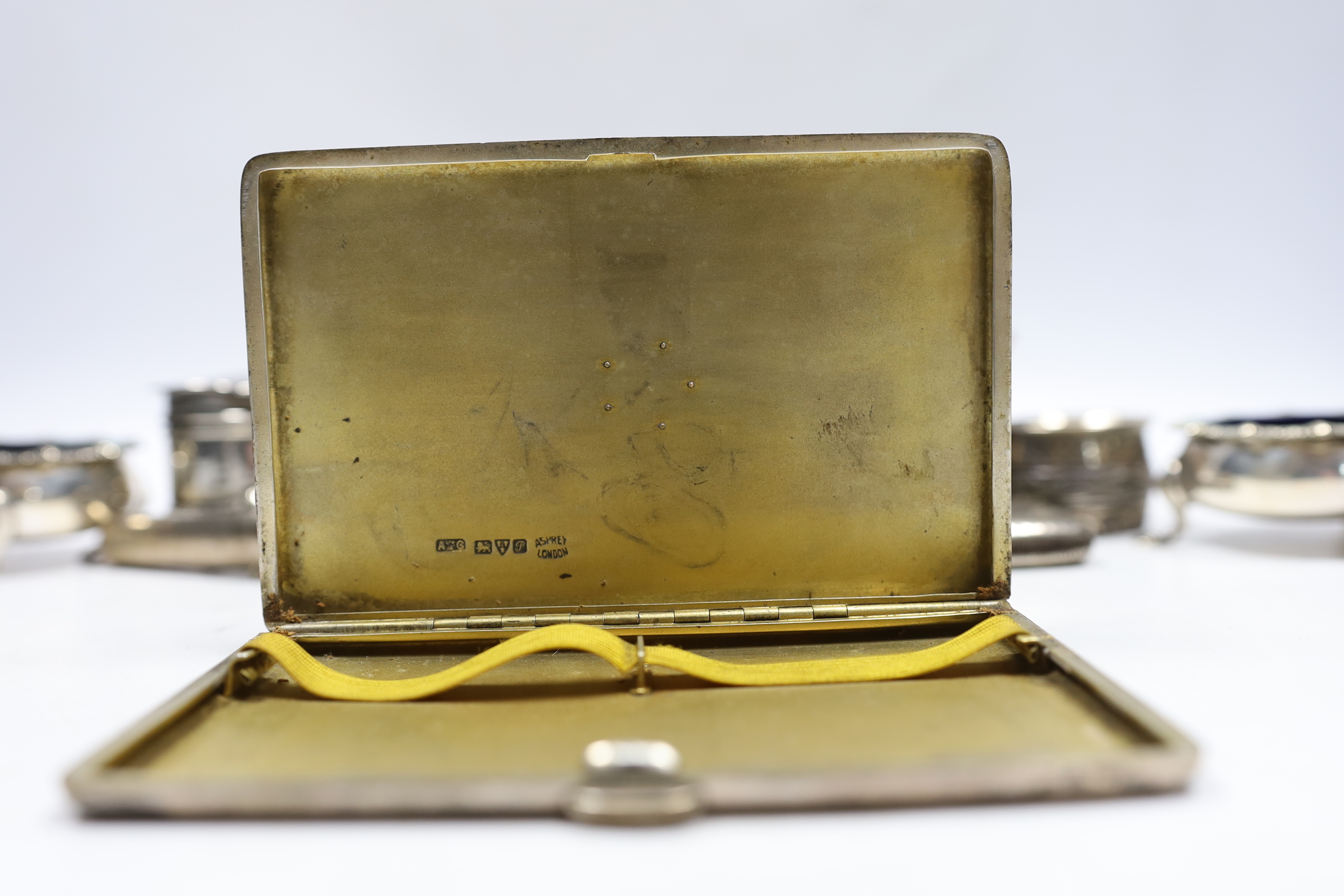 Sundry small silver including an Asprey silver cigarette case, 12.7cm, napkin ring, trinket box, pair of salts, vesta, small vase and a cheroot holder case, together with a plated napkin ring.